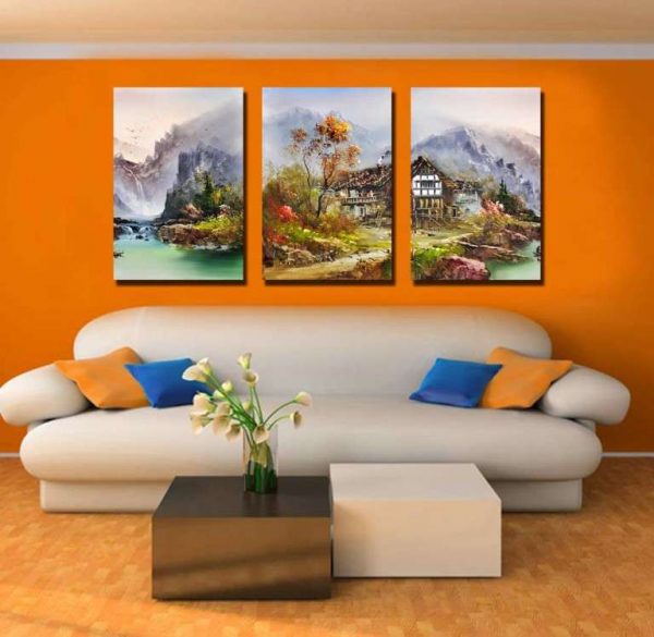 модульная картина с видом дома на фоне гор в интерьере гостиной над диваном