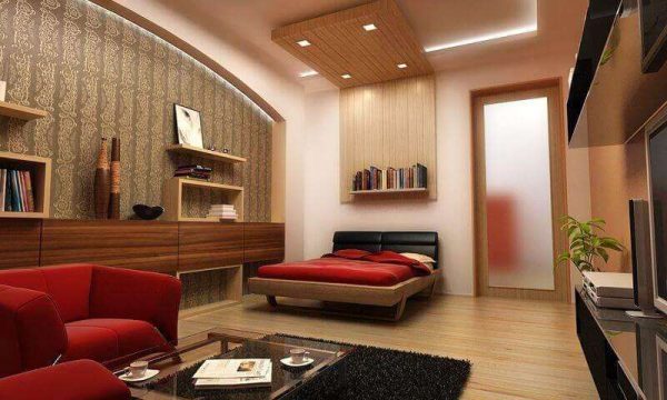 красная мебель в совмещённой спальне с гостиной