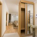 entrancing-sliding-door-narrow-walk-in-wardrobe-furniture-design-for-small-space-with-mirror-also-calm-brown-color-and-wooden-floor-ideas